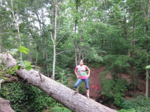 Maria on a log over a ravine.